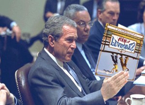 George Dubya Bush takes a break during a cabinet meeting to read Madonna's latest book, Mr. Peabody's Apples.